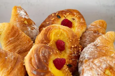 a pile of pastries with strawberries on them at Prima Guest House Collection in Rome