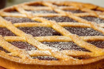 a pie with powdered sugar on top of it at Prima Guest House Collection in Rome