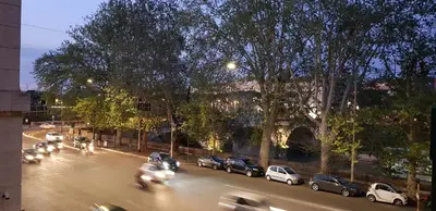 a city street with cars parked on the side of the road at Prima Guest House Collection in Rome