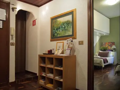 a room with a shelf with shoes on it at Holiday in Rome in Rome