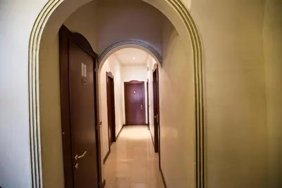 an arched hallway with an archway and a door at Hotel Lella in Rome