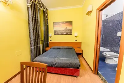 a small bedroom with a bed and a toilet at Hostel Beautiful in Rome