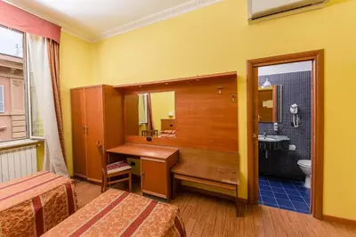 a bathroom with a sink and a toilet and a mirror at Hostel Beautiful in Rome