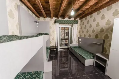 a small room with a bench and a window at Hostel Beautiful in Rome