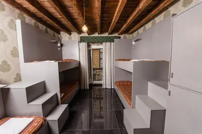 a room with three bunk beds and a hallway at Hostel Beautiful in Rome