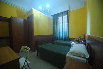 a hospital room with two beds and a window at Hotel Beauty in Rome