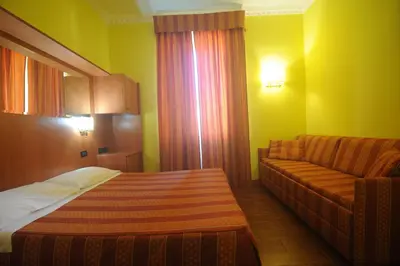 a hotel room with a bed and a couch at Hotel Beauty in Rome