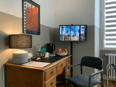 a room with a desk with a lamp and a chair at La Design.aTA Experience Bed & Breakfast in Rome