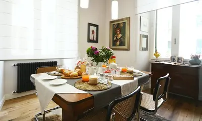 a dining room with a table with food on it at La Design.aTA Experience Bed & Breakfast in Rome