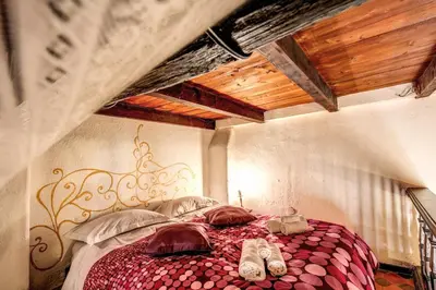 a bedroom with a bed with shoes on it at La Scala in Rome