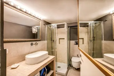 a bathroom with two sinks and a shower and a toilet at La Scala in Rome