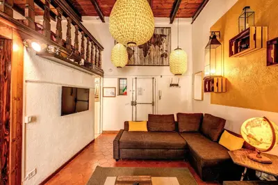 a living room with a couch and a tv at La Scala in Rome