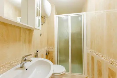 a bathroom with a shower and a sink and a toilet at Flower guesthouse in Rome