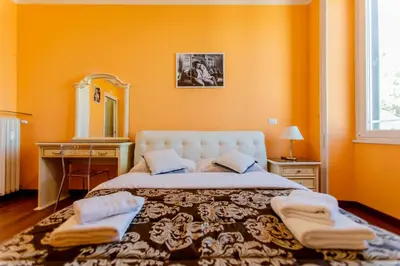 a bedroom with a large bed and a mirror at Flower guesthouse in Rome