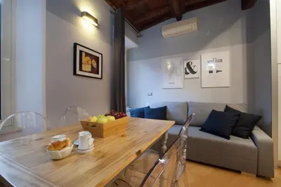 a living room with a table and a couch at Delle Grotte Apartment in Rome