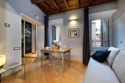 a living room with a table and a couch at Delle Grotte Apartment in Rome