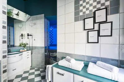 a bathroom with black and white tiled walls at Delle Grotte Apartment in Rome