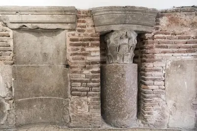 an old brick wall with a column on it at Delle Grotte Apartment in Rome