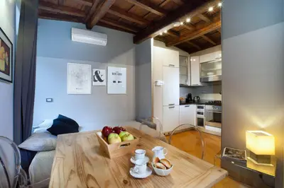 a kitchen with a table with a box of fruit on it at Delle Grotte Apartment in Rome