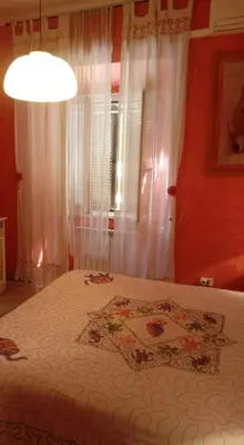 a bedroom with a bed and a window with curtains at Max House in Rome