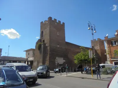 a tall brick building with cars parked on a street at Max House in Rome