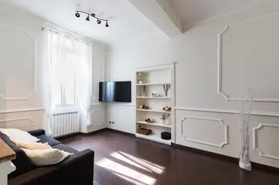 a living room with a couch and a tv at Frattina Royal in Rome