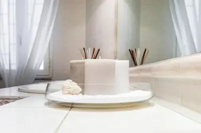 a white cake on a glass plate on a table at Frattina Royal in Rome