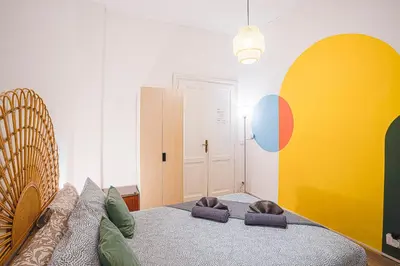 a bedroom with a bed with two cats sleeping on it at BigFamilyRome - Testaccio Riverside in Rome