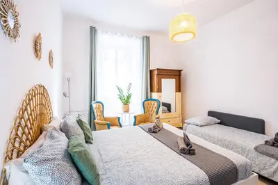 a bedroom with two beds and two chairs at BigFamilyRome - Testaccio Riverside in Rome
