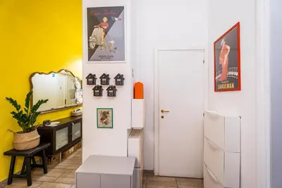 a kitchen with yellow walls and a white refrigerator at BigFamilyRome - Testaccio Riverside in Rome