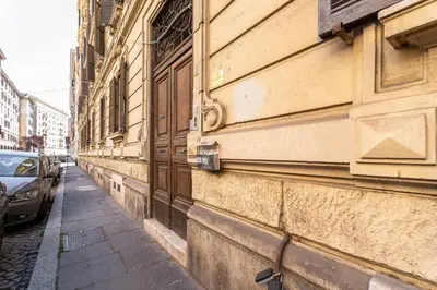 a building with a car parked next to a street at BigFamilyRome - Testaccio Riverside in Rome