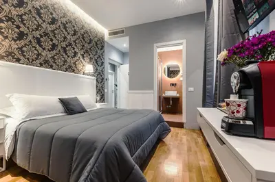 a bedroom with a king sized bed and a television at Bed And Best in Rome