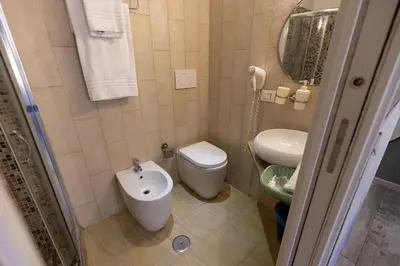 a small bathroom with a toilet and a sink at Bed And Best in Rome