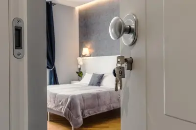 a bedroom with a bed and a door with a key at Bed And Best in Rome