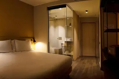 a hotel room with a bed and a glass door at The Place in Rome