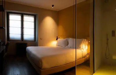 a bedroom with a bed and a glass shower at The Place in Rome