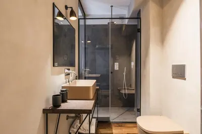 a bathroom with a sink and a glass shower at The Place in Rome
