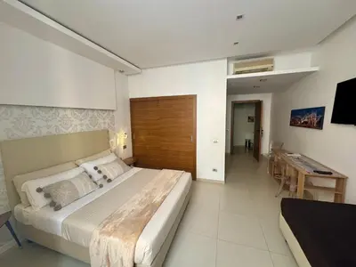 a large bedroom with a large bed and a desk at Interno 5 B&B in Rome