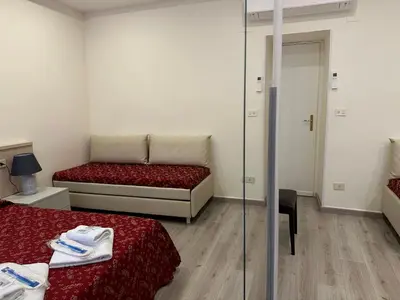 a small room with two beds and a glass wall at Casa Vacanza Vahid in Rome