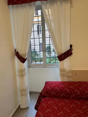 a bedroom with a bed and a window at Casa Vacanza Vahid in Rome