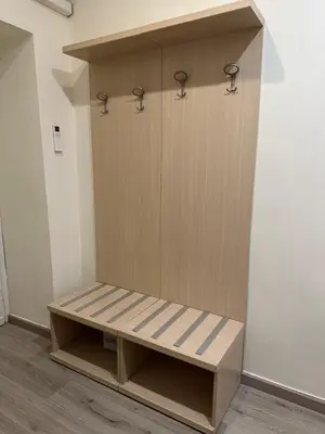 a locker room with a wooden bench in a room at Casa Vacanza Vahid in Rome