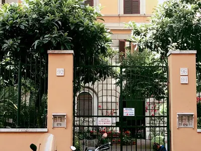 a black gate with trees in front of a building at Casa Vacanza Vahid in Rome