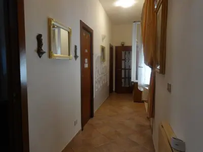 a hallway with a door and a mirror on a wall at B&B Twins in Rome