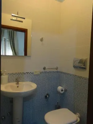 a bathroom with a sink and a toilet and a mirror at B&B Twins in Rome