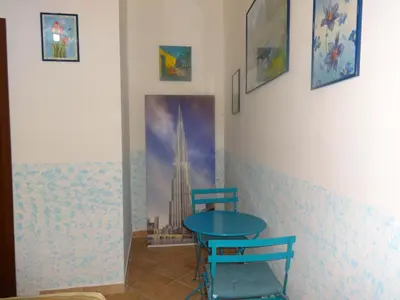 a room with two blue chairs and a table at B&B Twins in Rome