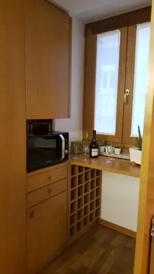 a kitchen with a microwave and a counter with a window at AmoRoma Francesca in Rome