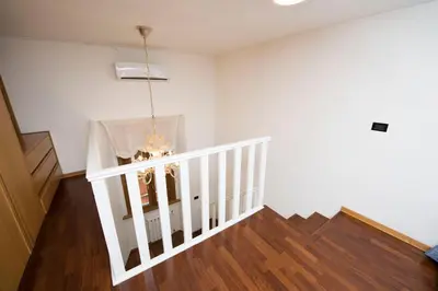 a white staircase in a house with a chandelier at AmoRoma Francesca in Rome