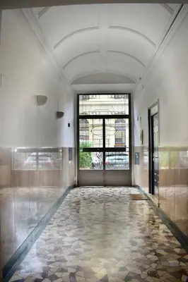 an empty room with a large window and a tile floor at Le Rondini a Roma in Rome