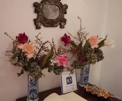 two blue and white vases with flowers on a table at Relais Teatro Argentina in Rome