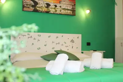 a green bedroom with a bed with green walls at Julius Caesar 183 in Rome